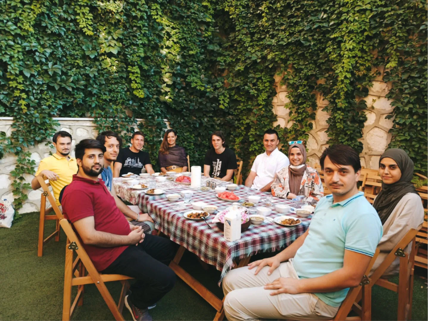 Volunteers and guests sharing a meal in the garden